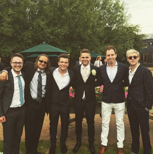 One Direction's guitarist Sandy Beales [4th from the left] also tied the knot this weekend! Niall made sure to drop by to his friend's wedding in THAT SAME suit that stole our hearts at the *Horan and Rose* charity event.