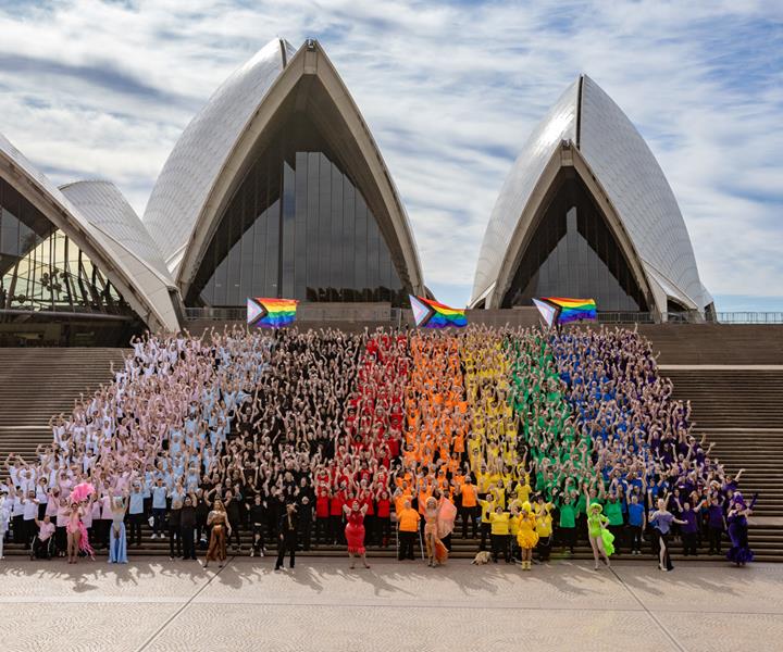 People dressed in rainbow colours on the steps of Sydney Opera House