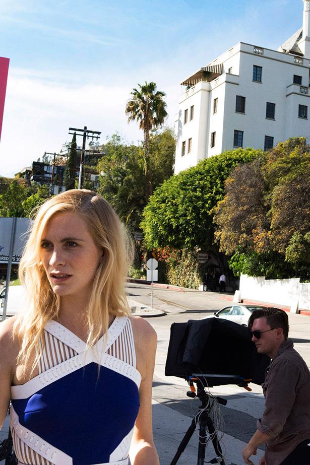 Delevingne poses outside the Chateau Marmont in a design by David Koma. "The dress is based on one of my favourite looks from SS14," says Koma. "The collection was inspired by the Japanese art of Kyudo. The dress, engineered from thick jersey, features waist cut-outs with protective lacing framed in leather." Photo: Andi Elloway