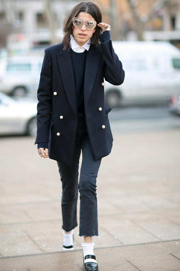 Leandra Medine's frilled ankle socks add a touch of girlishness to her masculine look.