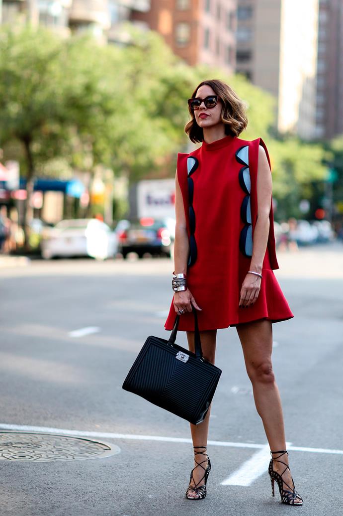 Shifting heads in a red mini dress teamed with a Chanel handbag and Alaïa lace-up heels.