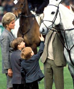 An undated photograph shows a family outing for the Princess with sons William, left and Harry at the polo in England.