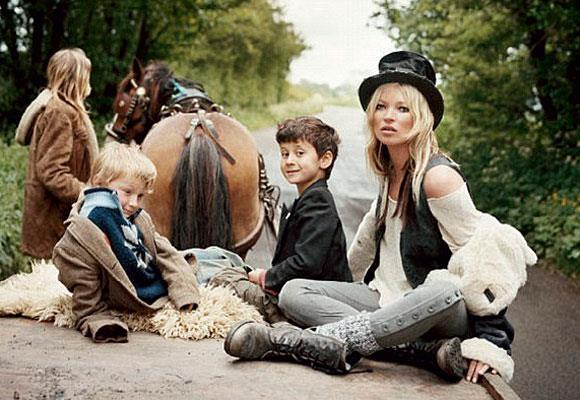 On top: Moss poses with gypsy children on top of a horsedrawn cart