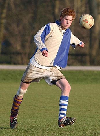 Prince Harry playing soccer in 2003.