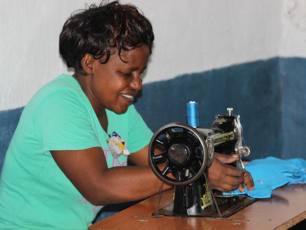 Rachel, the Goods for Girls schools liaison officer, at the sewing machine.