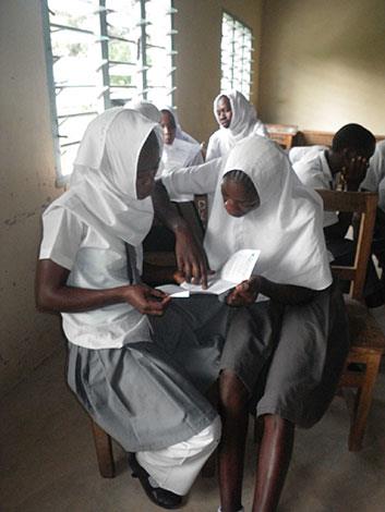 Muhaka students read the women’s health pamphlets distributed by Goods for Girls.