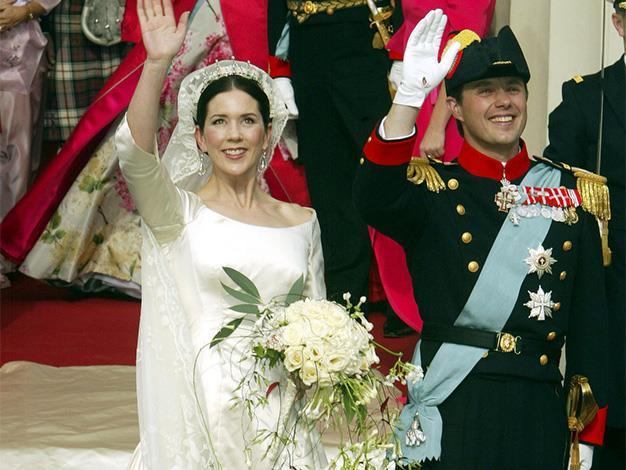 The newlyweds wave to crowds following their wedding ceremony.