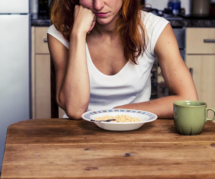 Woman unhappy eating cereal