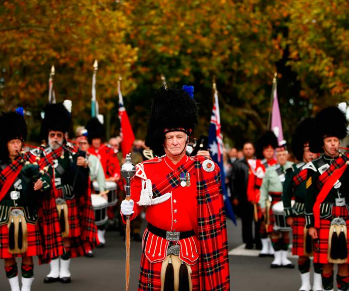 Members of the Scottish community salute the fallen in Auckland, New Zealand.