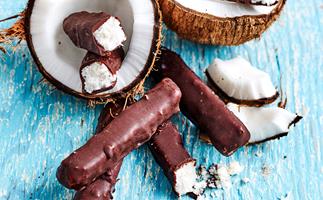 Dark chocolate bars with coconut on display with coconut shells.