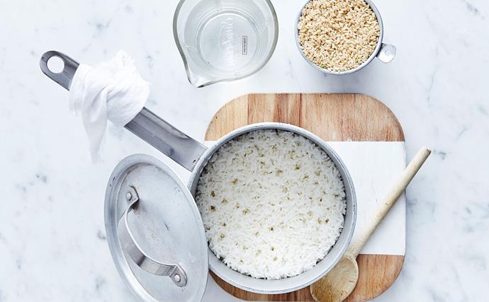 white rice being cooking in a pan