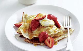 Crepes with maple syrup, strawberries, and cream