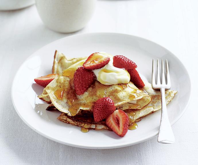 Crepes with maple syrup, strawberries, and cream