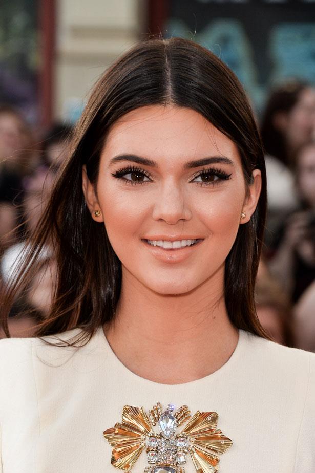 Bold lashes and a peachy lip glam-up Jenner's casual brushed out straight hair.