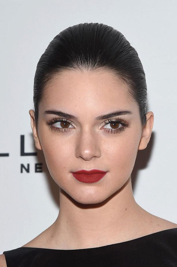 Kendall kept her look classic with spidery lashes, a matte red lip and slicked back hair in 2014.