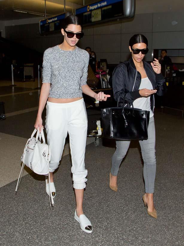 <p>July 10, 2014</p> <p>Kendall Jenner and older sister Kim Kardashian seen at LAX.</p>