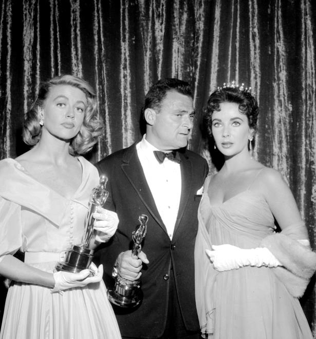 Ingrid Bergman definitely held her own next to Elizabeth Taylor in a belted and buttoned dress with short white gloves in 1956.