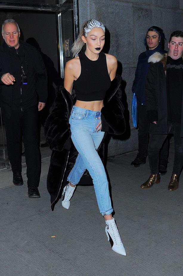 Exiting the Fenty x Puma show, Gigi wore blue jeans, a black crop top and pointed boot.