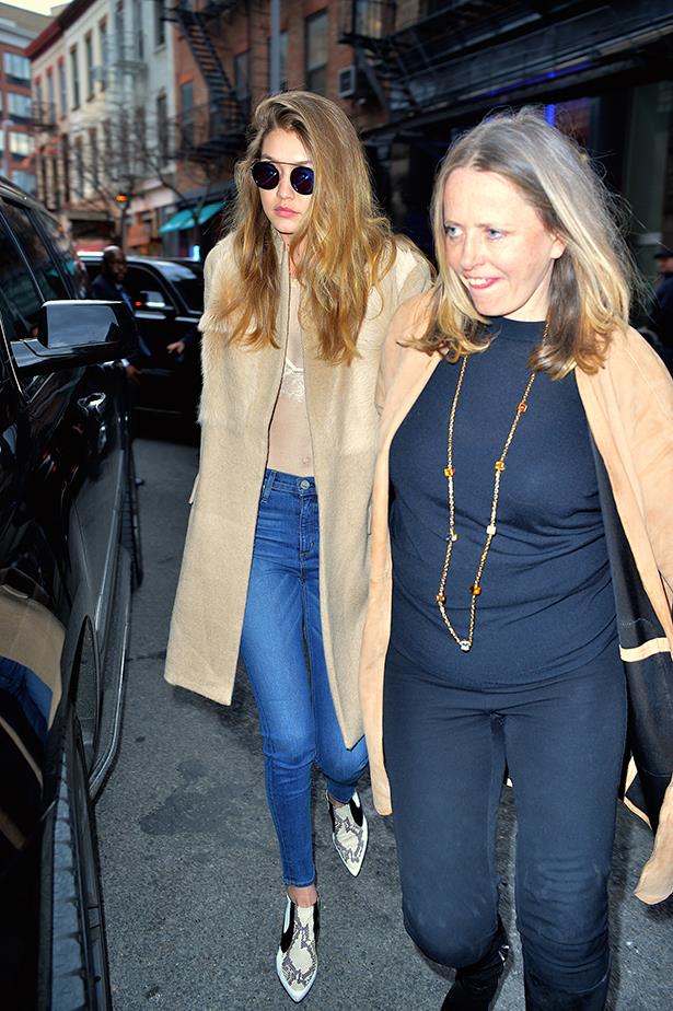Gigi paired her sheer white top with a lace bra, blue jeans and pointed boots in New York.