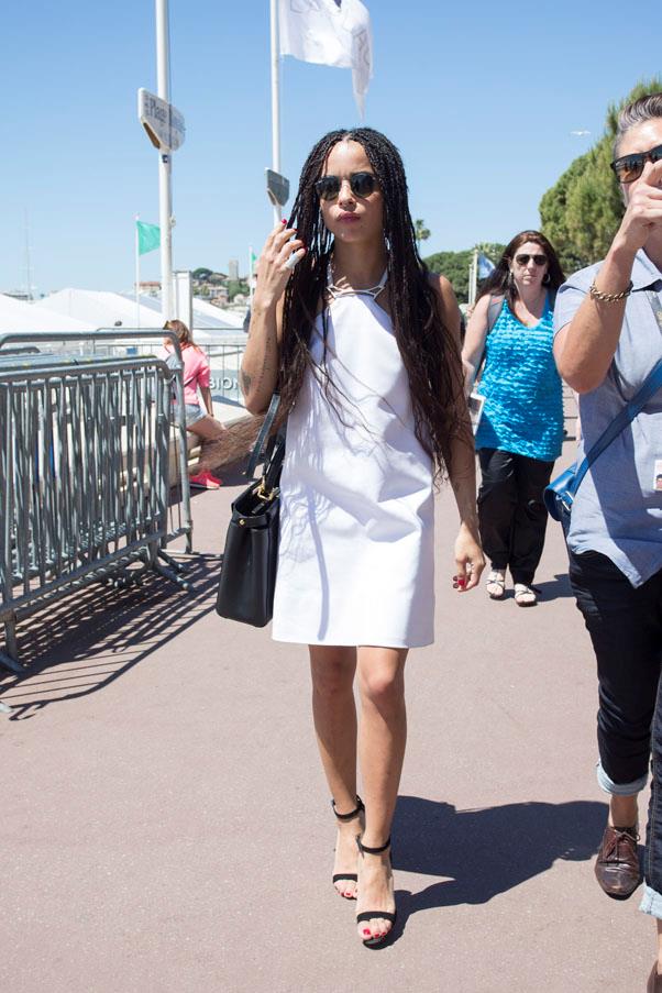 Kravitz wearing a simple white shift dress and her signature black shades while out and about in Cannes.