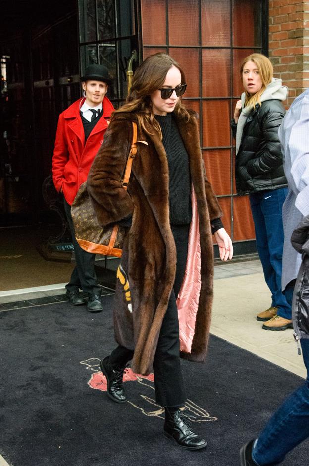 Dakota stepped out in this brown fur Gucci coat, but, of course, the best detail was on the back...