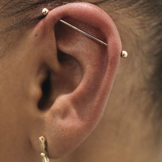 **INDUSTRIAL PIERCING**<br><br>

An industrial piercing usually involves two piercings in the ear's cartilage. The two holes are then connected by one piece of jewellery. Kylie Jenner has an industrial piercing.<br><br>

**Healing time:** 6 to 12 months.<br><br>

*Image via [@bentauber](https://www.instagram.com/p/BQnsUZYhfcg/|target="_blank"|rel="nofollow")*