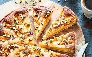 Apricot and pistachio tart on wooden board