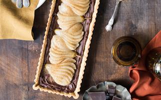 pear and chocolate tart on wooden table