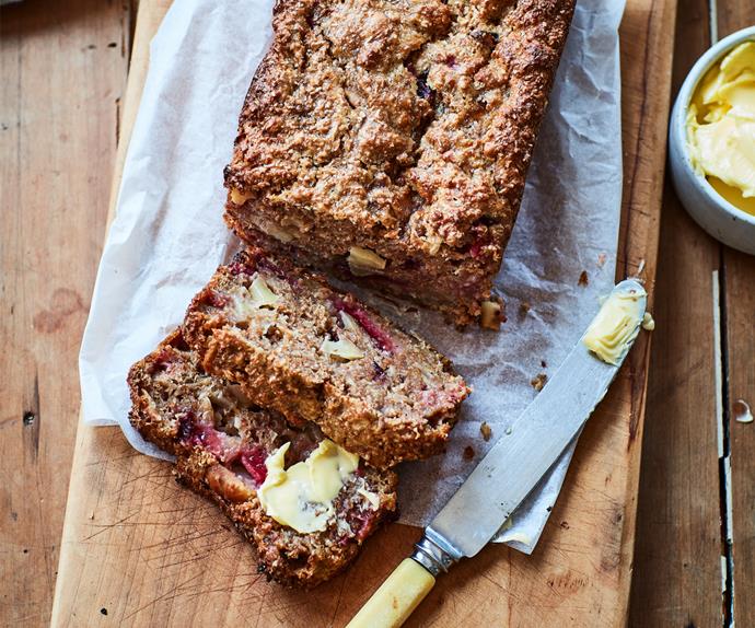 Apple and plum bran loaf on wooden board