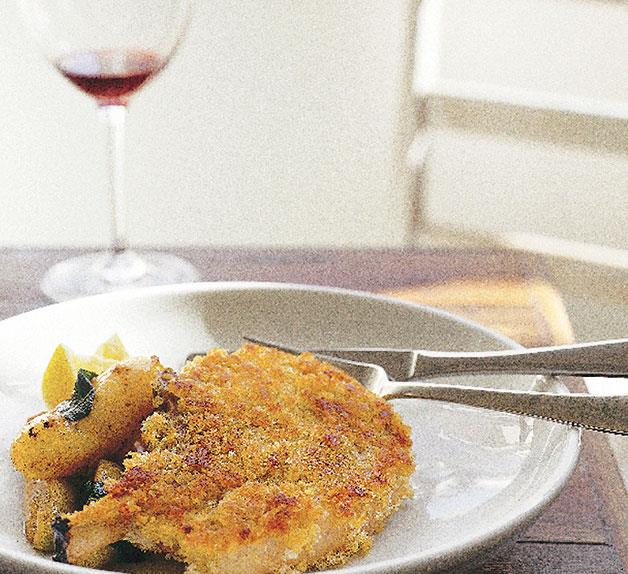 Crumbed pork cutlet with sautéed apples, potatoes and sage