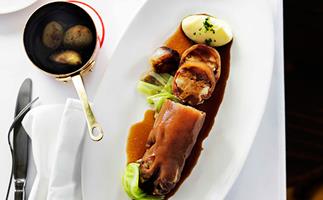 Braised stuffed pig's trotters with cabbage, shallots and potato purée