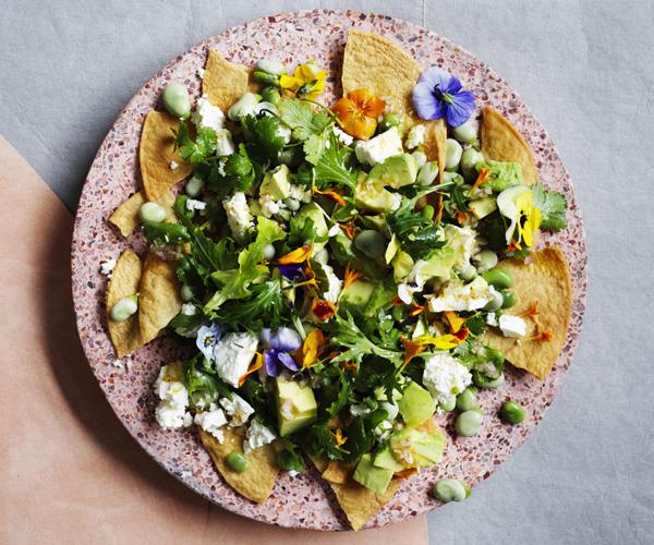 Fried tortillas with broad beans, feta and lime