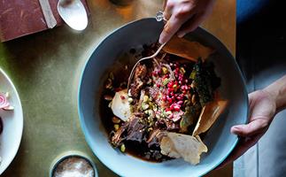 Slow-roasted lamb shoulder with pistachios, pomegranate and vine leaves