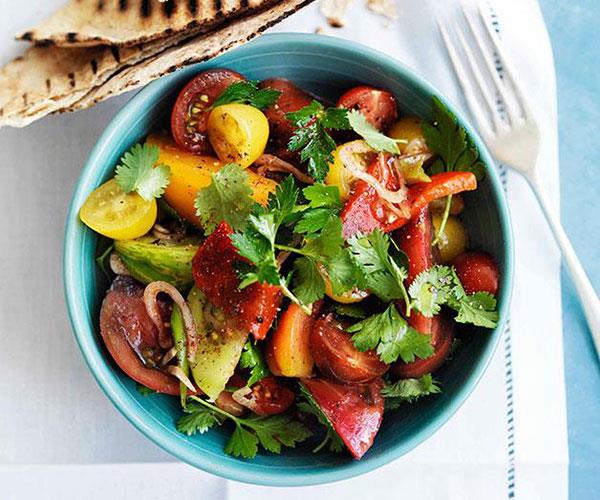 Mixed tomato salad with sumac, herbs and flatbread