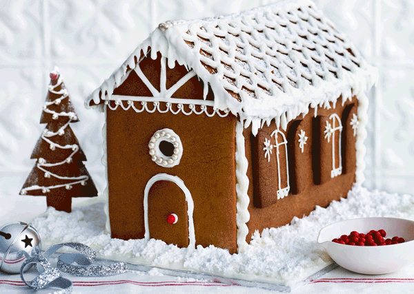 A .gif video showing a gingerbread house being constructed and iced.