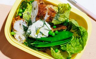 Roast chicken salad with peas and almond-lemon dressing in a yellow lunchbox