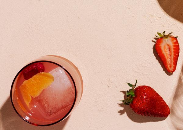 Glass of Rosé Spritz with strawberries on the side. 