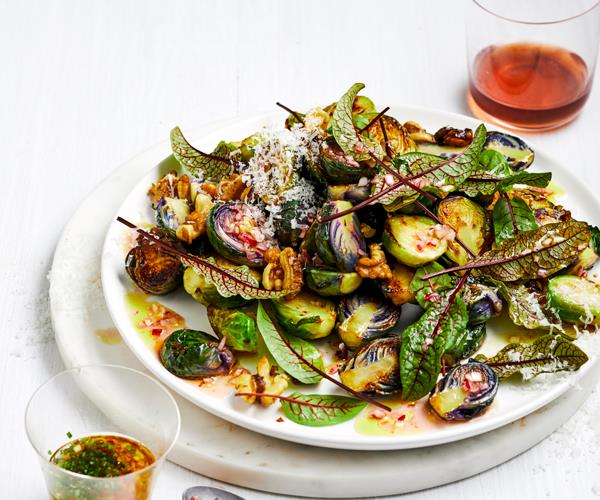 Salad of fried Brussels sprouts and sorrel leaves on a white plate