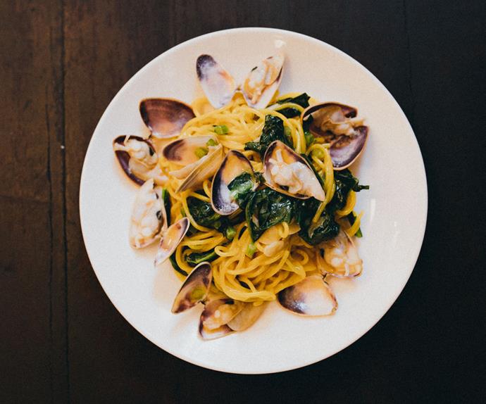 Overhead image of spaghetti and clams on a white plate