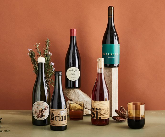 Natural wine bottles with a dusty terracotta background