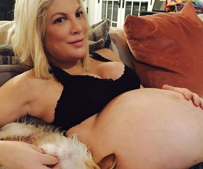 As she neared the birth of her fifth child (a boy!), Tori Spelling took to Instagram to share a ready-to-pop shot of her baby bump. The 43-year-old captioned the very-relaxed pic with, "Just #kickinit couchside with my bump and my furboo watching the #superbowl."