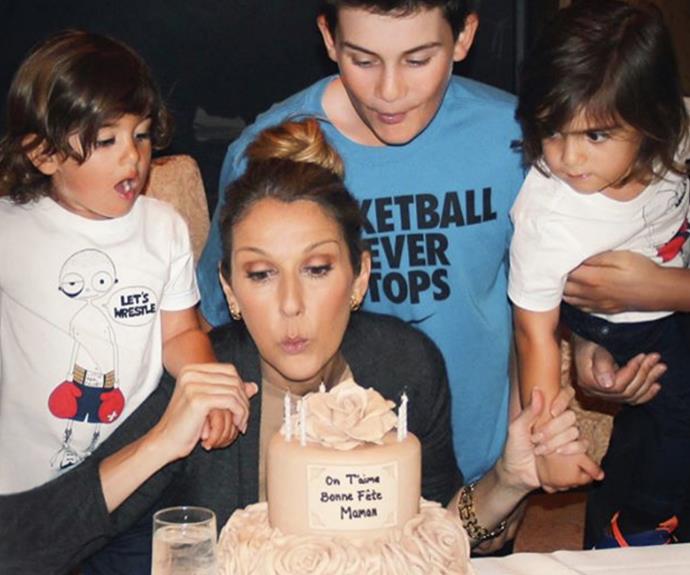 All the boys together! Celine blows out the candles in 2013 with her loving children - Rene, Nelson and Eddy.