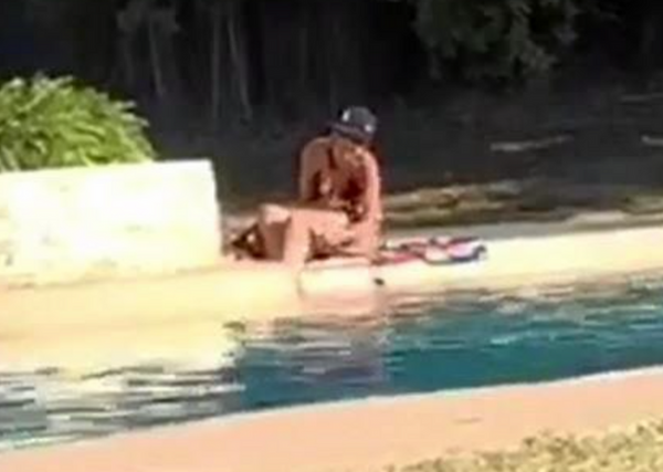 Woman shaving legs in public pool 