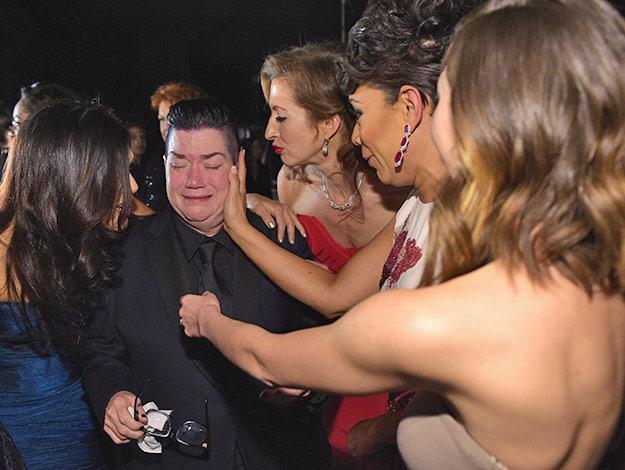 Orange is the New Black cast members comfort their costar Lea DeLaria who is overcome with emotion after winning the award for Outstanding Performance by an Ensemble in a Comedy Series