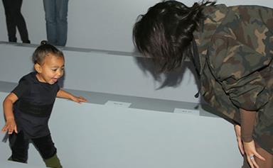 A rare look at Kim Kardashian playing with North West backstage at Kanye's show