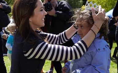 Mary, Crown Princess of Denmark presents a little girl with a crown in the spirit of anti-bullying