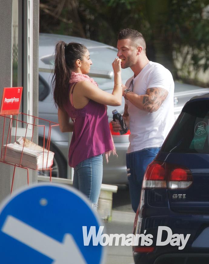 The couple share a snack as they are snapped on a busy Auckland street.