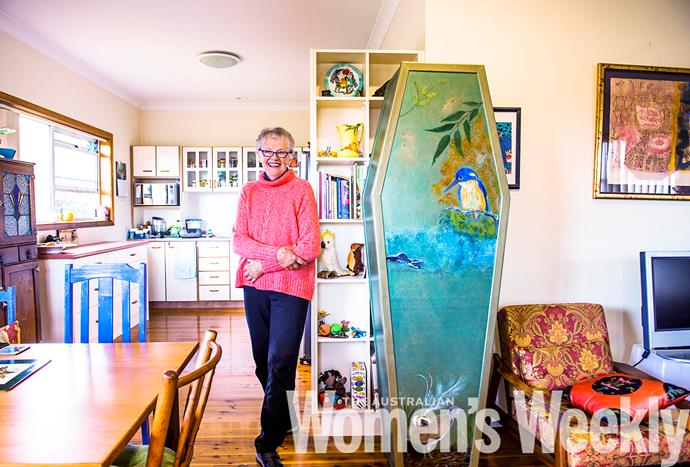 Kate Worth shows off her cardboard coffin, which she bought online for $130 and has transformed into her own style. PHOTO: Tim Bauer.