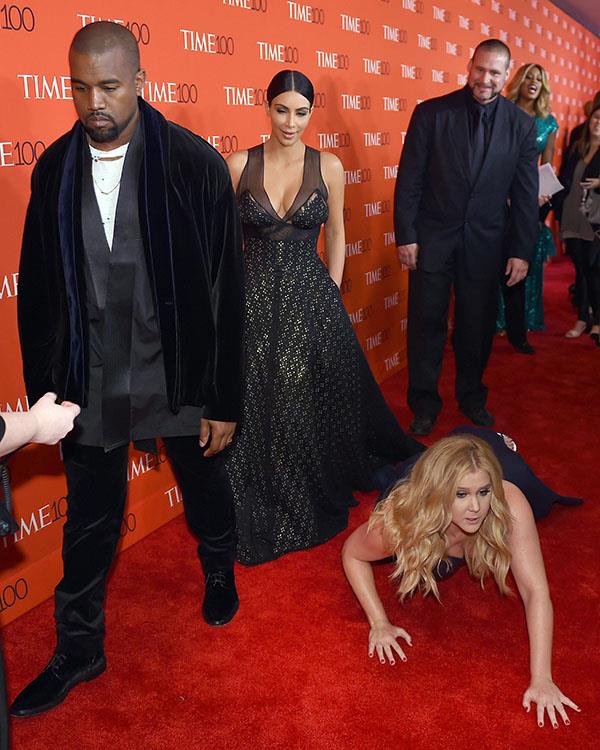 Amy Schumer aka 'Queen of red carpet stunts' throws herself in front of Kim Kardashian and Kanye West - a move that delighted many but, not Yeezy.