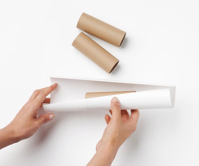Cut decorative paper into lengths and wrap snugly around each roll with a 4cm overhang at each end to disguise the bangers you will later thread in. Secure paper around roll with double-sided tape.
